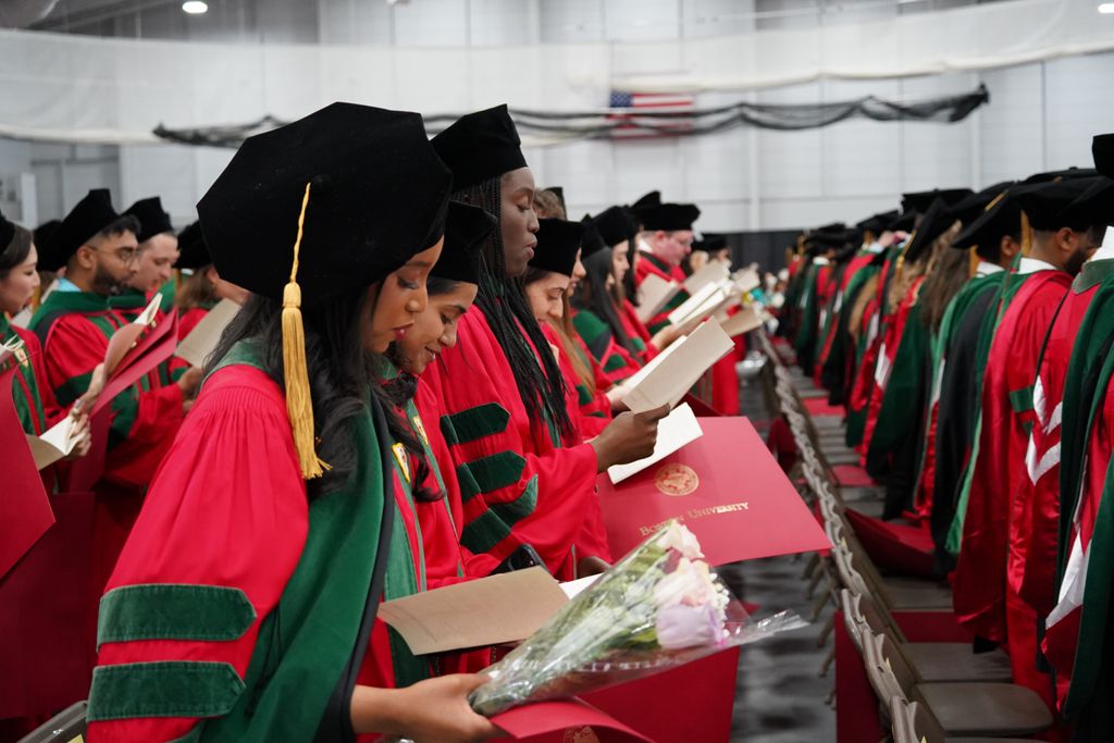 MD students in regalia seated reciting Hippocratic Oath