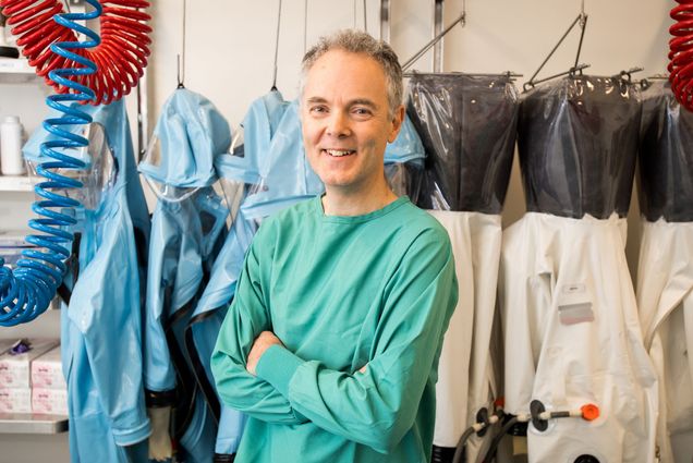 Robert Davey in clean room garb smiling broadly