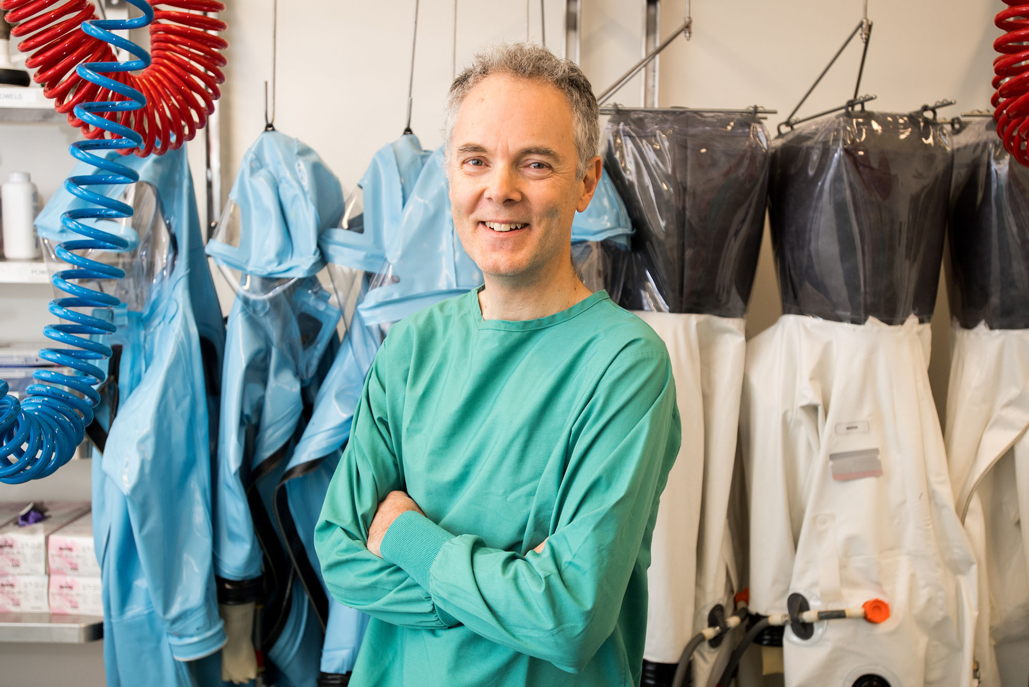 Robert Davey in clean room garb smiling broadly
