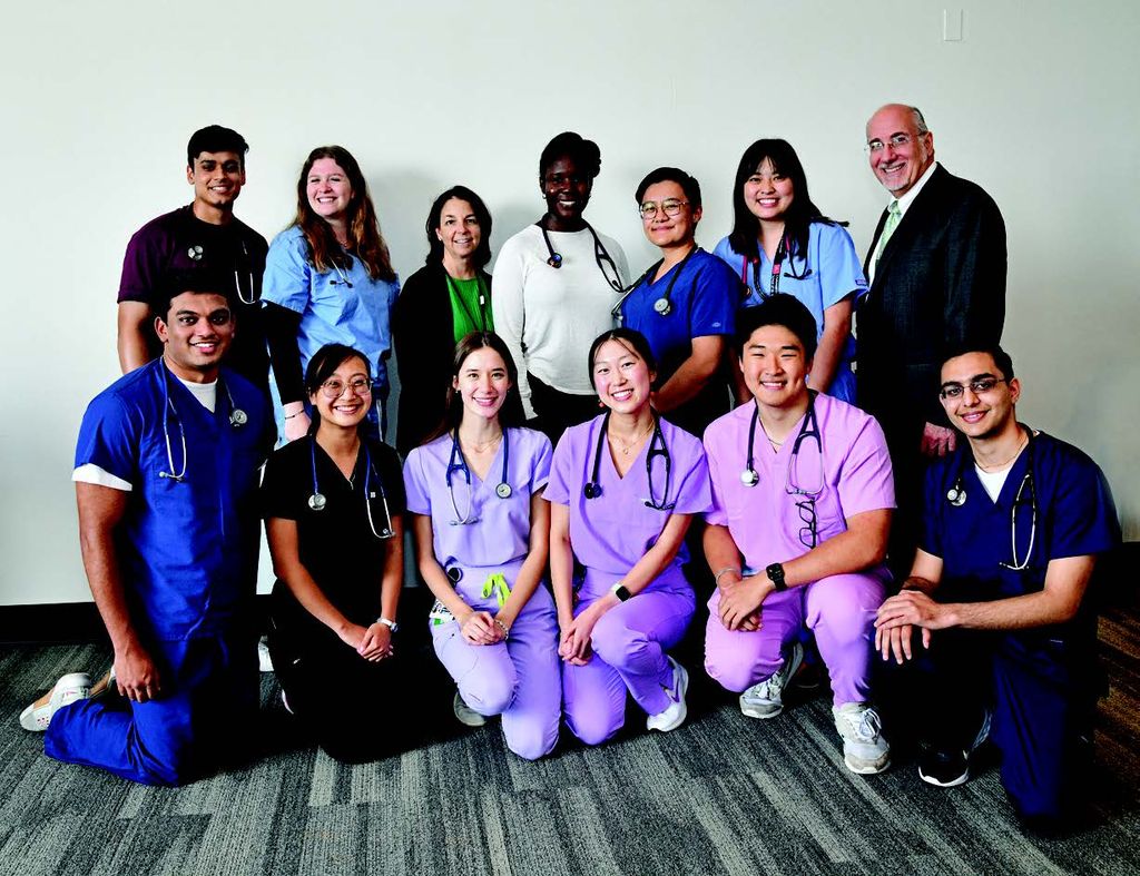 A group of first-year medical students pose for a photo with keynote speaker Stephen Tringale after the lecture.