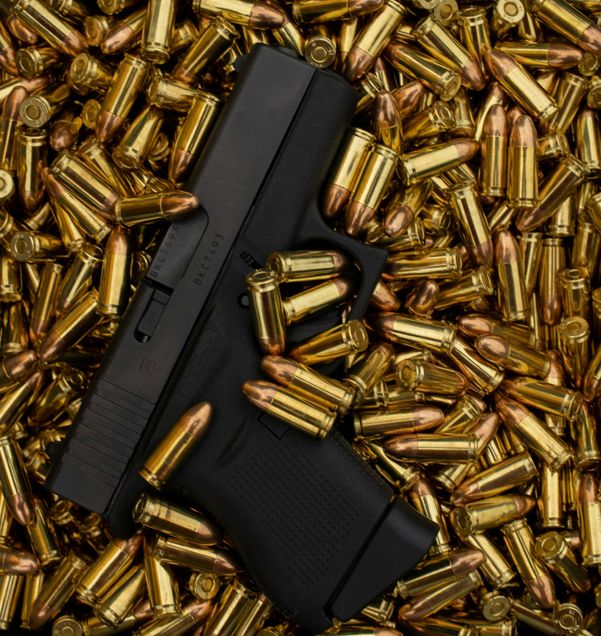 Gun with bullets. Photo by Jay Rembert on Unsplash