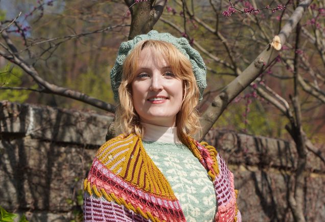 Kristen Segars standing outside wearing a gold and ping handknit cartigan sweater