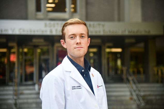 portrait of Aksel Laudon wearing white coat infront of Instructional Building
