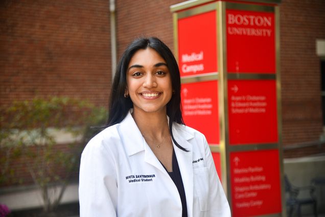 Portrait of Nikihita Santenbennu wearing whitecoat outside of instructional buildingr
