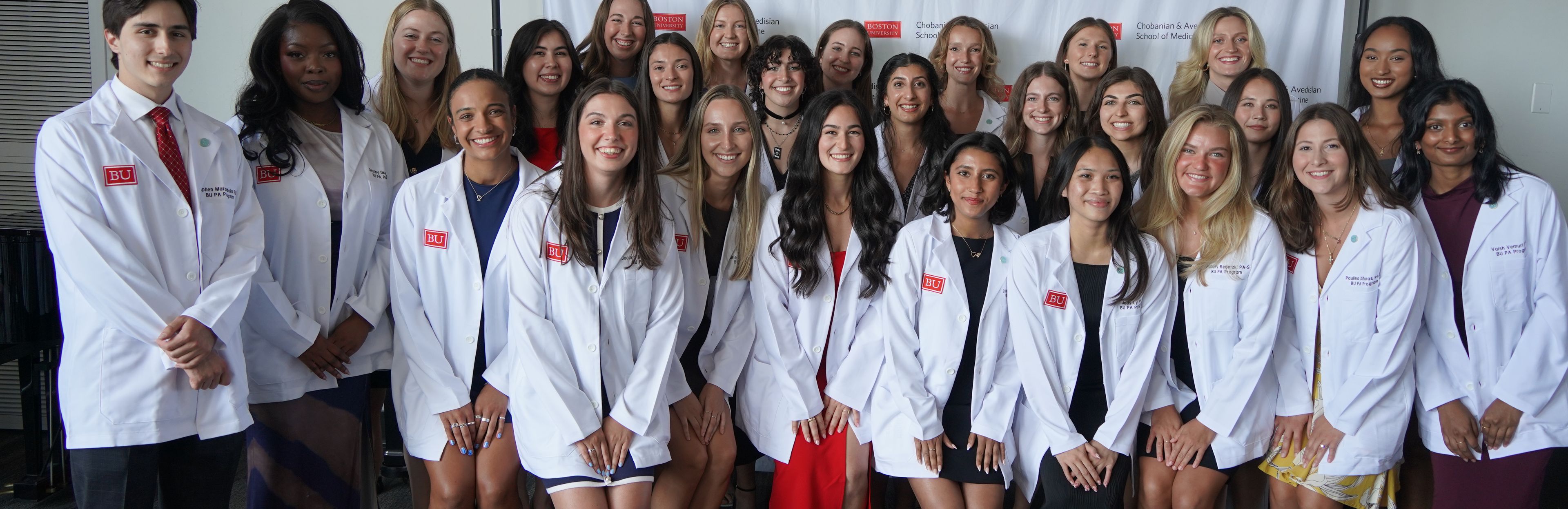 PA Students in white coats at ceremony