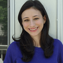 Head and shoulders of Nicole Roth in blue shirt long dark hair