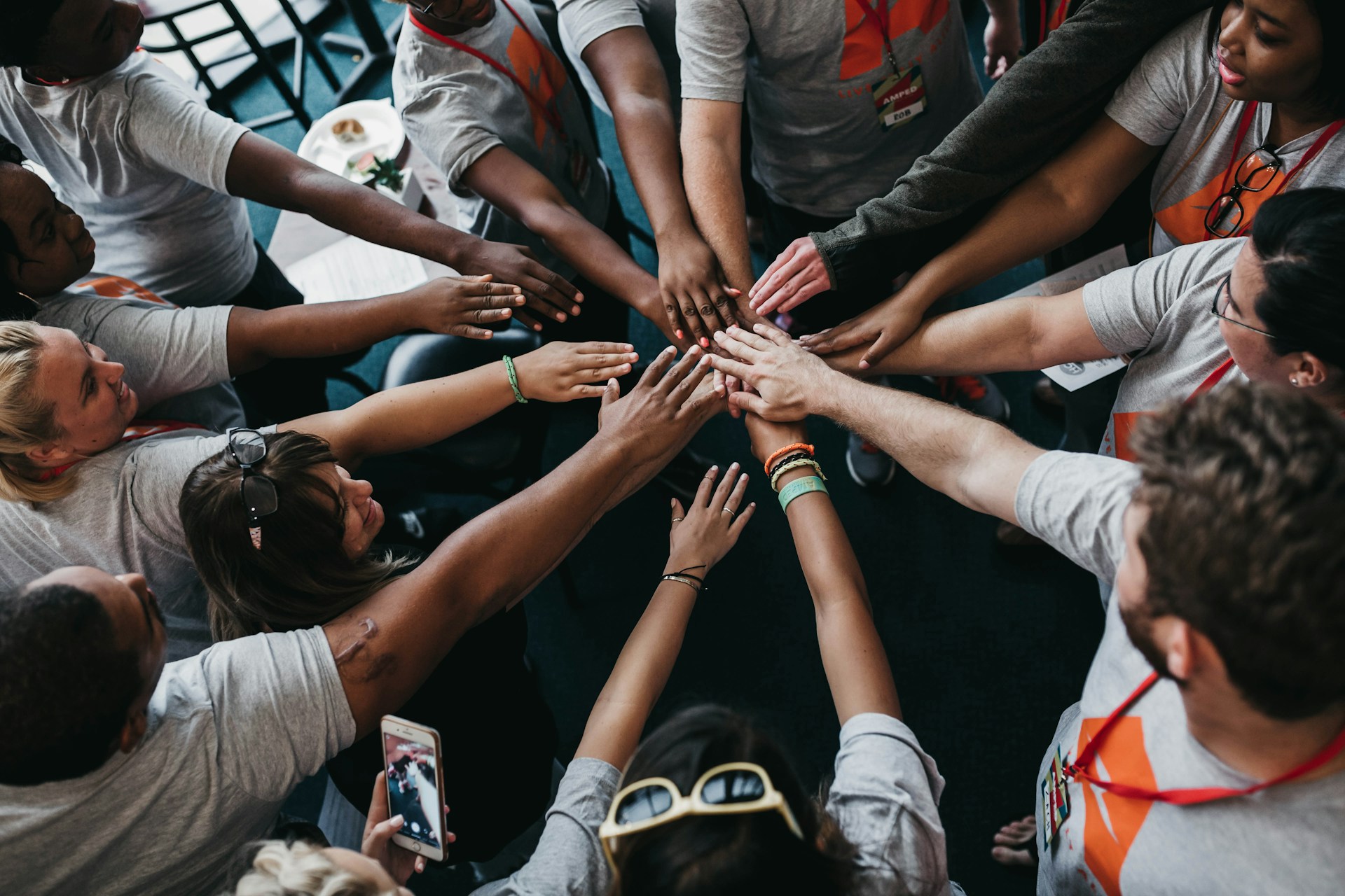 People with hands gathered in the middle.