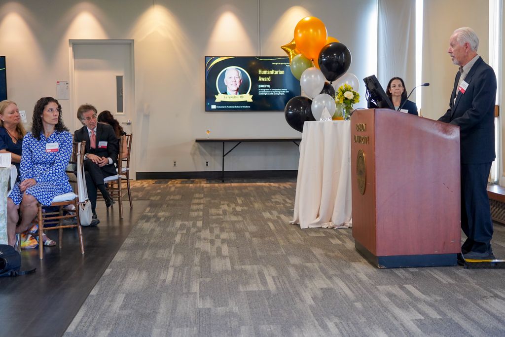 Larry Nichter at podium addressing crowd