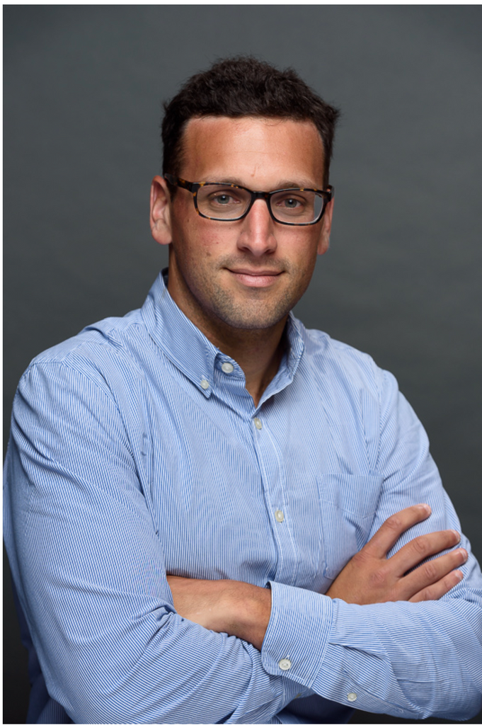 Michael Alosco blue shirt, arms folded