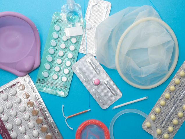 Variety of forms of contraception against a blue background