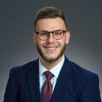 head and shoulders of Maxim Petrovsky in suit