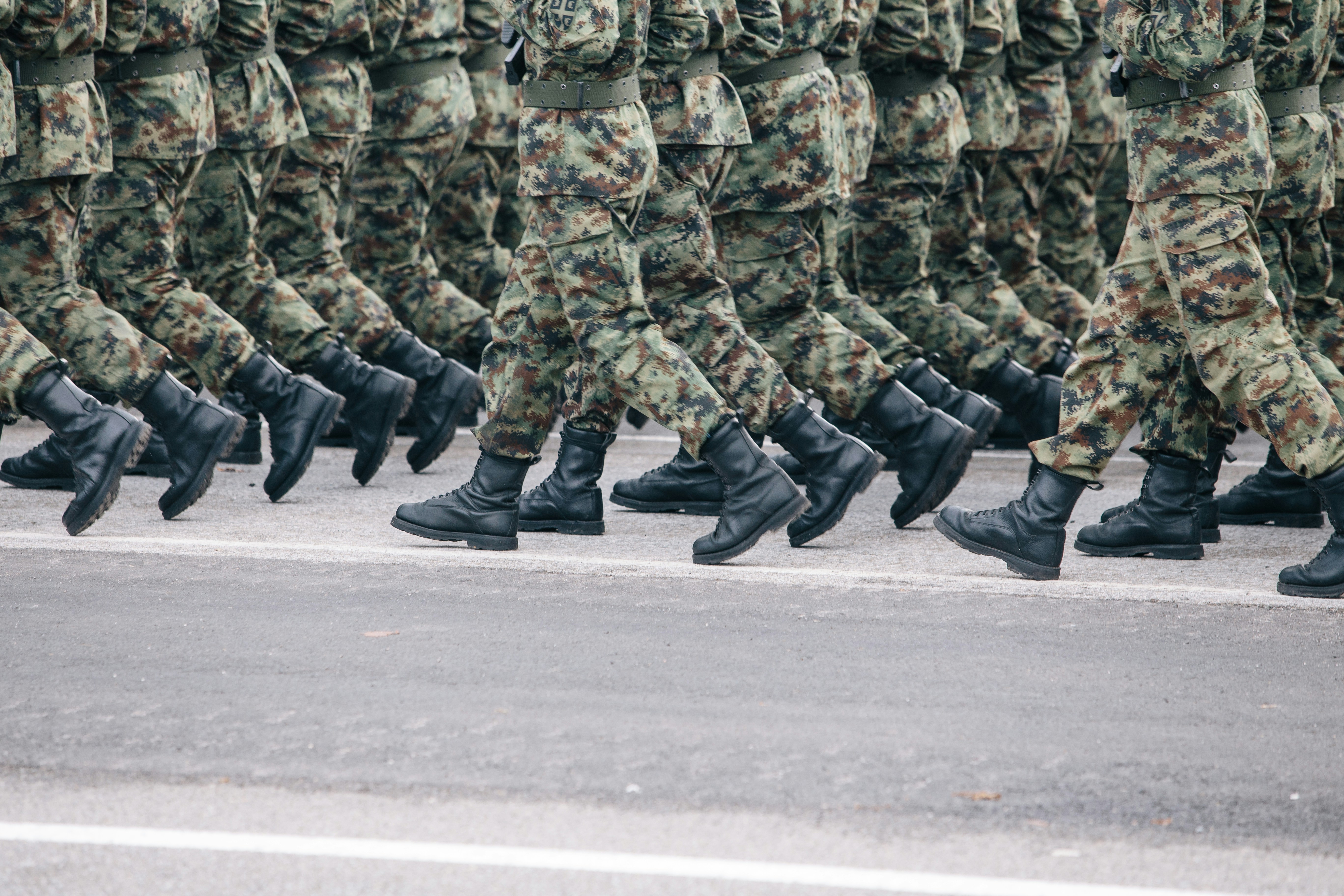 image of soldiers in camo marching in unison