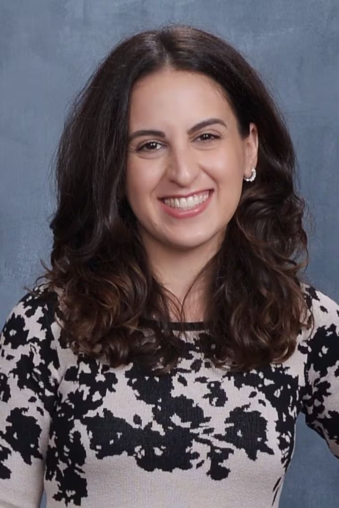 Portrait of Monica Crespo, long dark hair, smiling