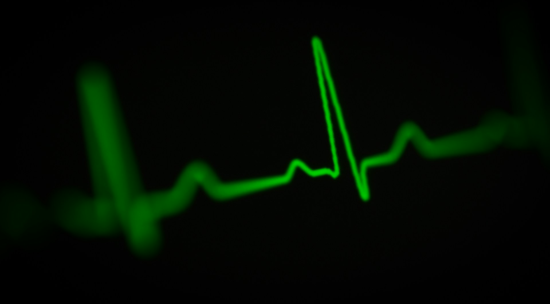 A green heartbeat on a black background.