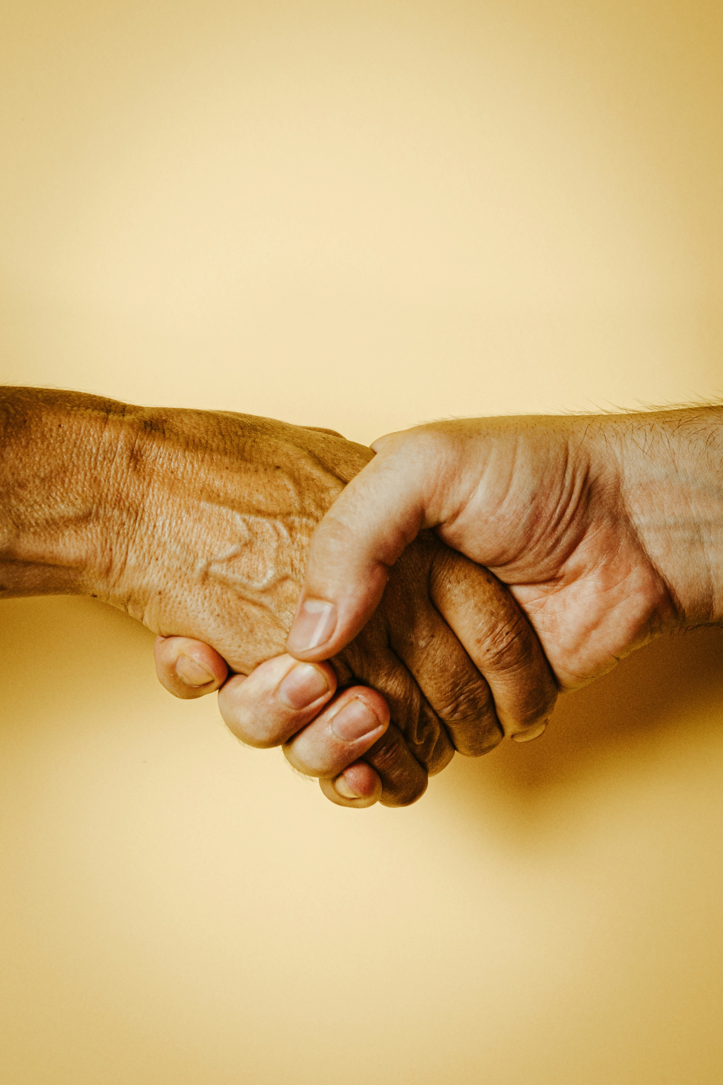 Two hands holding one another