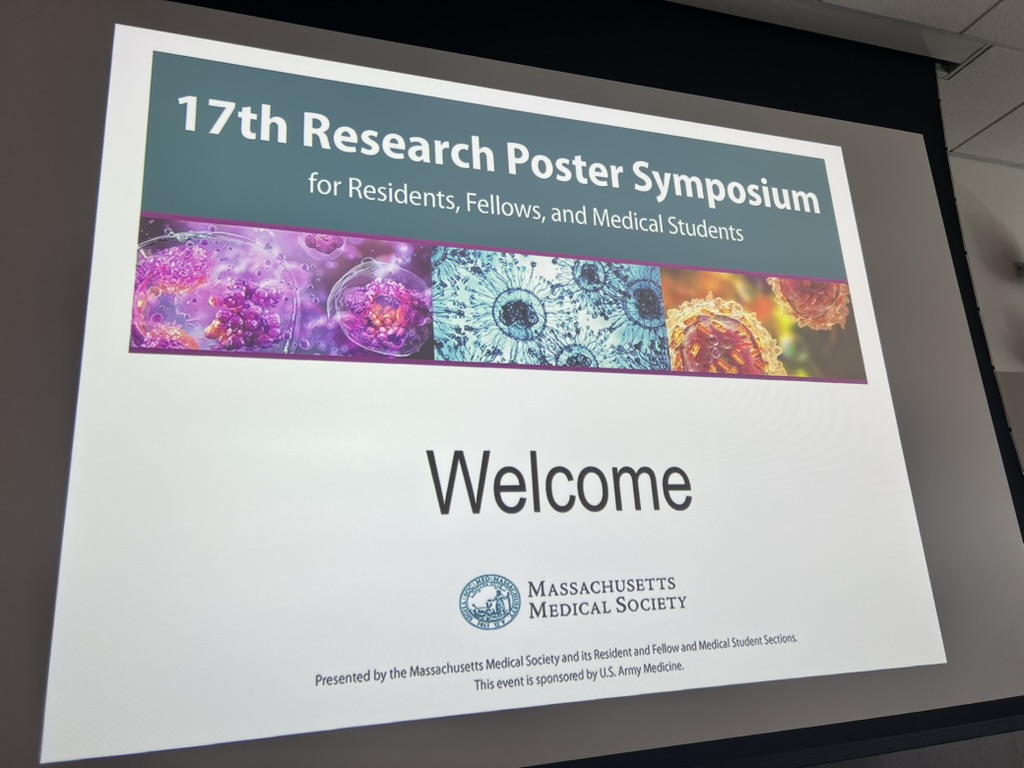 Flatscreen powerpoint slide welcoming to the Research Poster Symposium