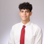 Head and shoulders of Marcelo Villafuerte wearing white shirt and red tie