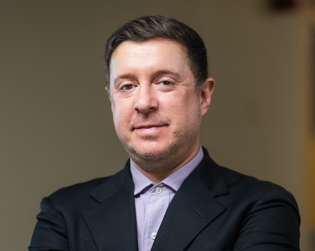 Formal head and shoulders of Casey Taft in dark suit jacket