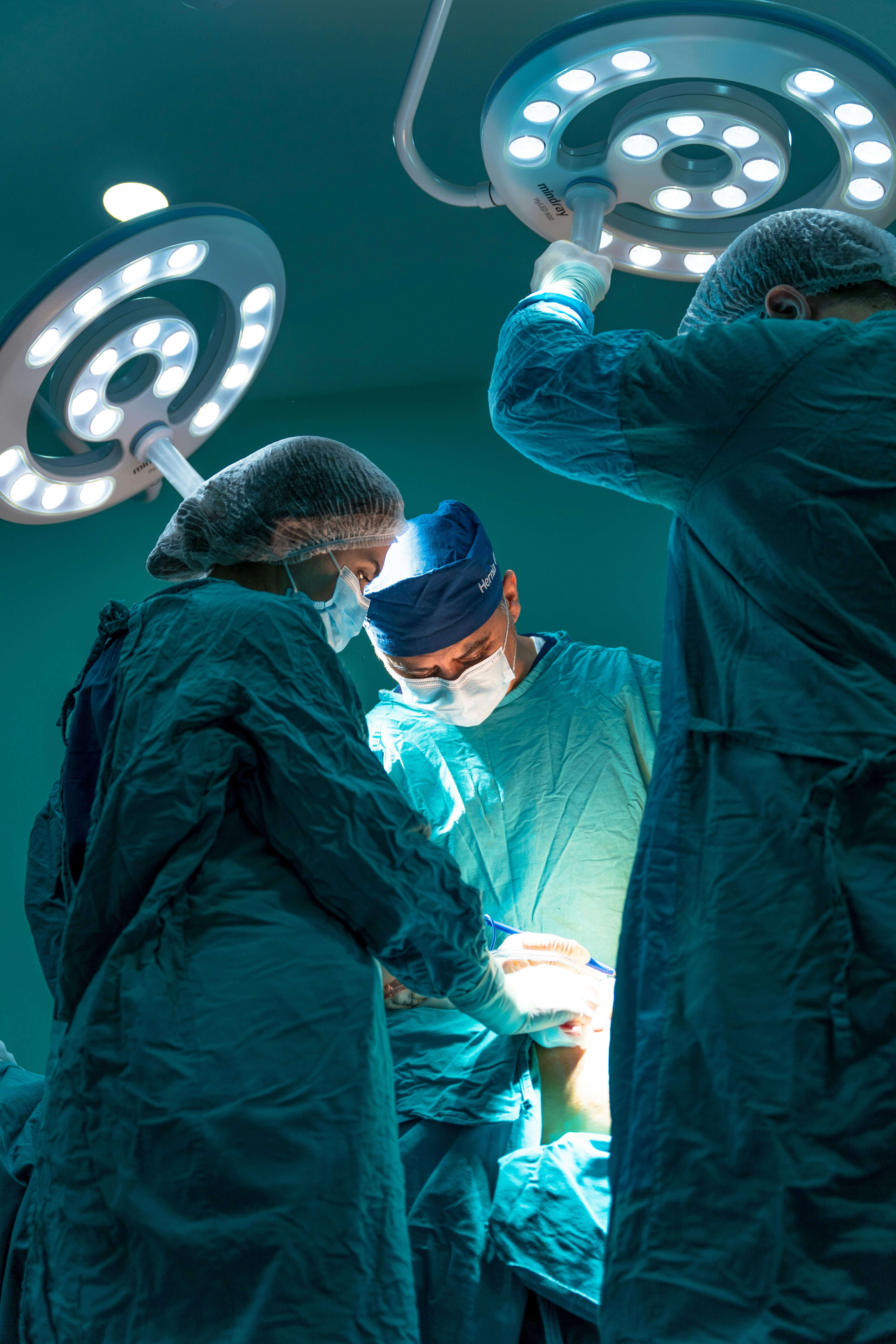 doctors in gowns and masks in operating room