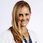 Woman with long blond hair, wearing whitecoat, smiling