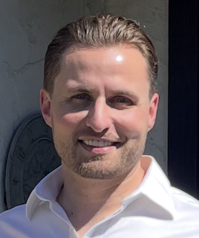 Man wearing white shirt, smiling
