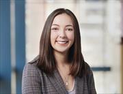 head and shoulders of owman with long straight brown hair smiling