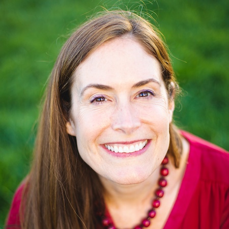 woman with long brown, straight hair, red top, smiling