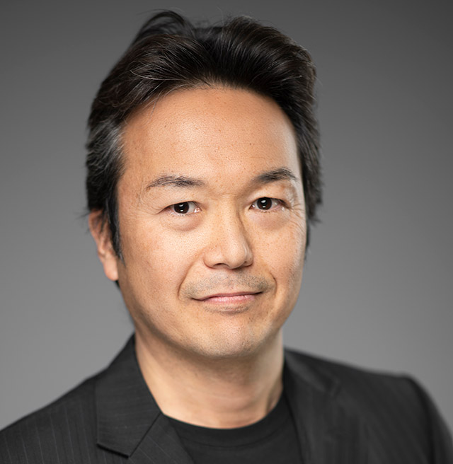 Man with black hair wearing black jacket and shirt