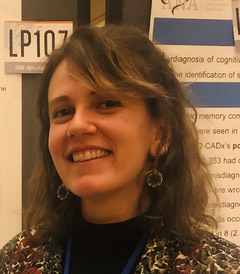 Woman with brown wavy hair smiling