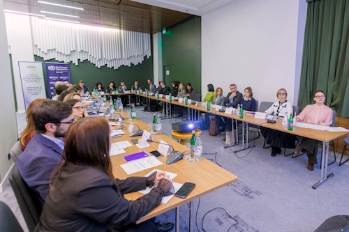Large group of people in a meeting at tables