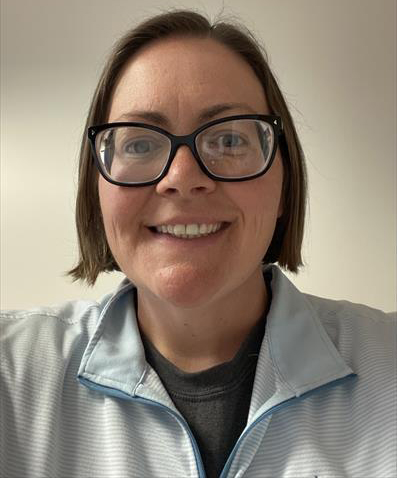 head and shoulders of woman with short straight hair, glasses, smiling