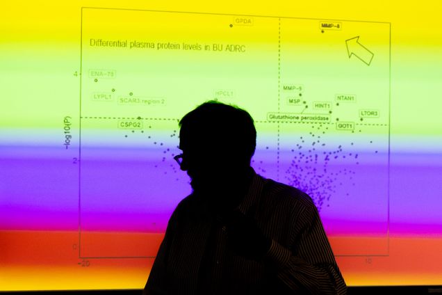 shadow of a man in front of screen with multicolored data