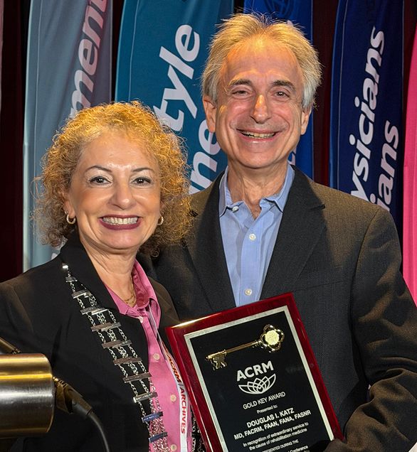 Dr. Katz on right receiving award from woman