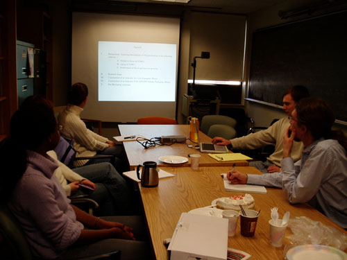 People sitting around a table during a presentation