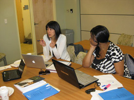 Teresa Ortiz (left) and Zainab Shuaib during a group meeting. Their group proposed a program that would train midwives and traditional birth attendants ways of educating communities about family planning methods and services.