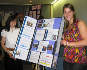 Sofia Redford (left) and Joy Nolte present a poster of the program they created for Circle of Health International as part of the course IH 744: Design & Implementation of International Health Programs.