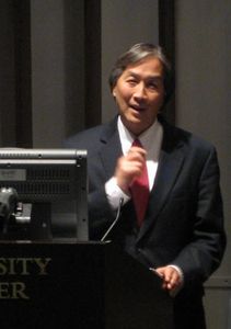 Howard Koh speaks to a packed auditorium CAPTION Howard Koh speaks to a packed auditorium at Boston University Medical Campus.