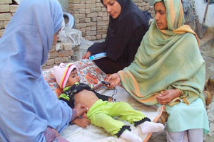 SPH sized Pakistan lady health workers treat a child with respiratory problems. Photo courtesy of Save the Children Pakistan lady health workers treat a child with respiratory problems. Photo courtesy of Save the Children.