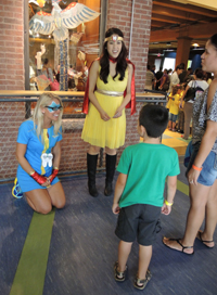 Lieutenant Fluoride (in blue) and Captain Cavity Fighter (in yellow) welcome a family at the Countdown Celebration