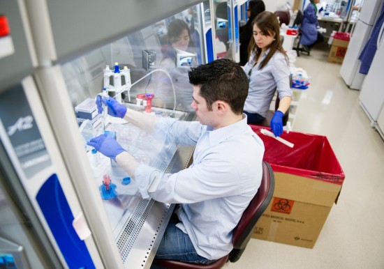 CReM technician Ryan Mulhern and Clarissa Koch (MED’16) pipette cell samples under ventilation hoods in CReM’s high-tech facilities. Photo by Jackie Ricciardi