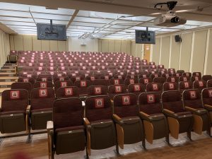 L110 Classroom, empty seats with signage indicating physically distant compliant seats