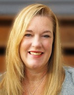 Headshot of owman with long blond hair smiling broadly