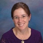 Brunette woman with glasses and a purple shirt