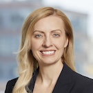 White woman with long strawberry blonde hair, smiling