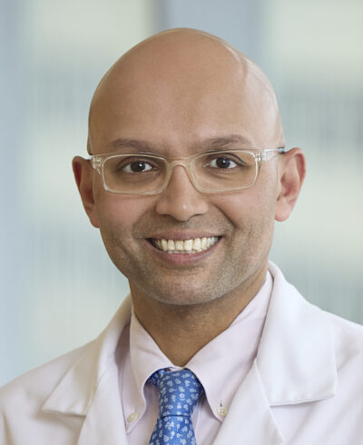 Head and shoulders of Omar Siddqi in whitecoat