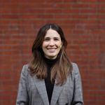 Sarah Gordon standing in front of a red brick wall