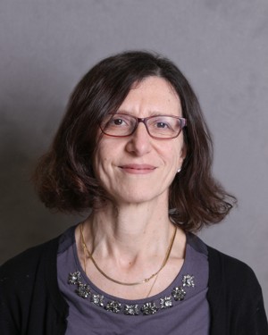 Woman with shoulder length brown hair and eyeglasses