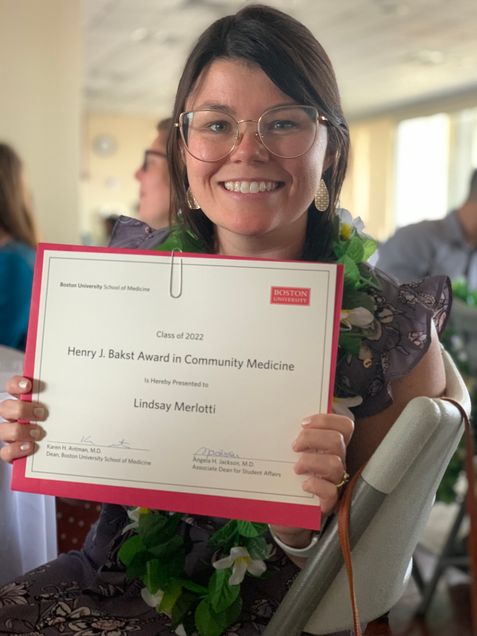 Lindsey Merlotti holding the Bakst Award certificate.