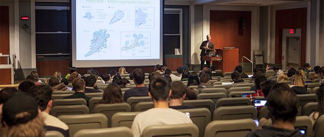 Professor lecturing students in classroom