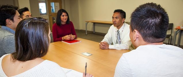 Professor and students holding discussion